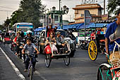 Riding the becak, the local cycle rickshaws in Malioboro street Yogyakarta. 